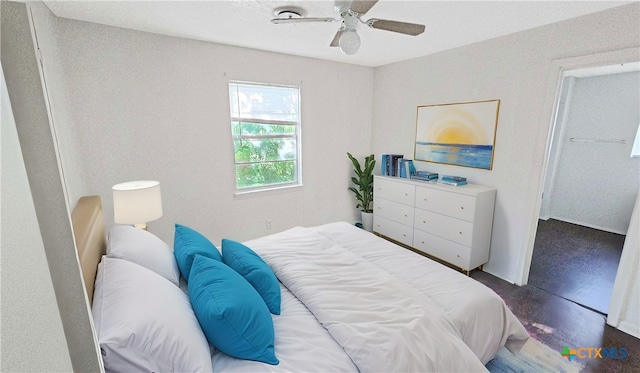 bedroom featuring ceiling fan and dark hardwood / wood-style floors