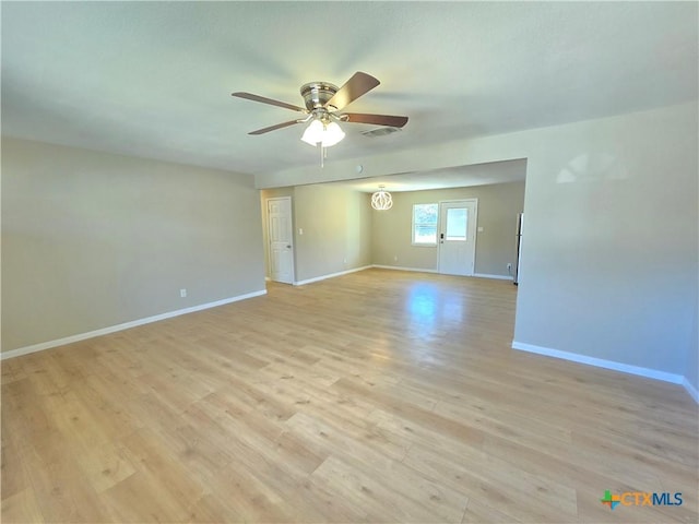 empty room with light hardwood / wood-style flooring and ceiling fan