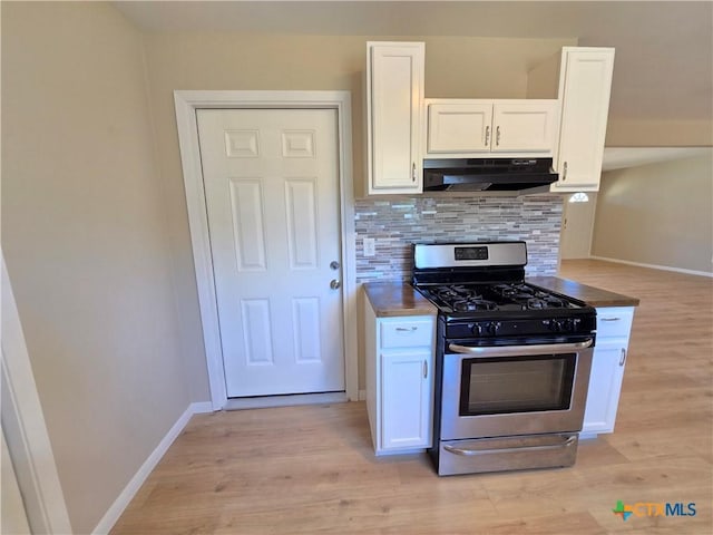 kitchen featuring stainless steel gas range oven, white cabinetry, light hardwood / wood-style floors, and decorative backsplash