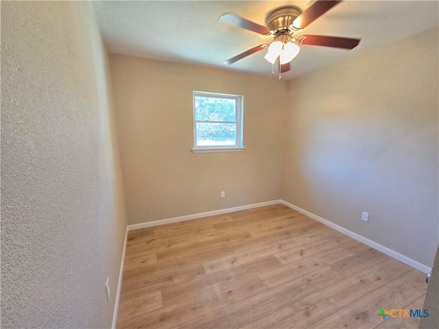 spare room with light hardwood / wood-style floors and ceiling fan