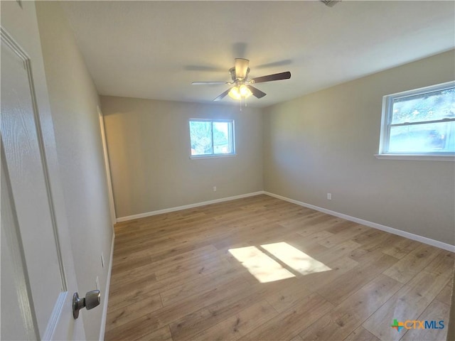 empty room with light wood-type flooring and ceiling fan