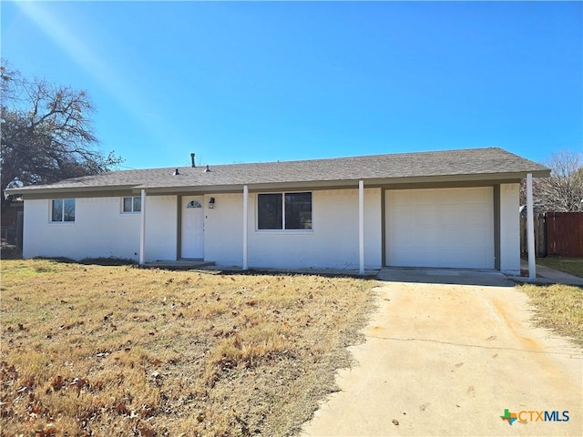 312 S Willis St, Lampasas, TX 76550 - ranch-style house with an attached garage, driveway, and stucco siding