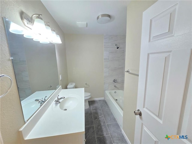 full bathroom featuring vanity, toilet, and tiled shower / bath