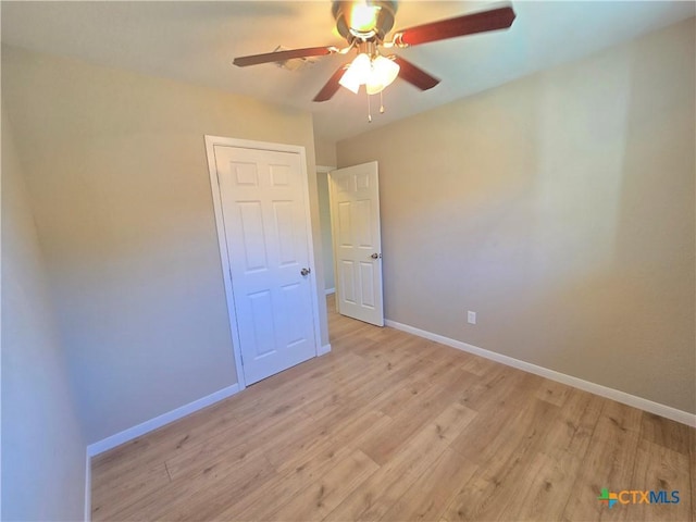 unfurnished bedroom featuring ceiling fan and light hardwood / wood-style floors