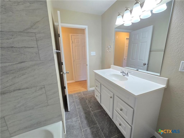 bathroom featuring a washtub and vanity