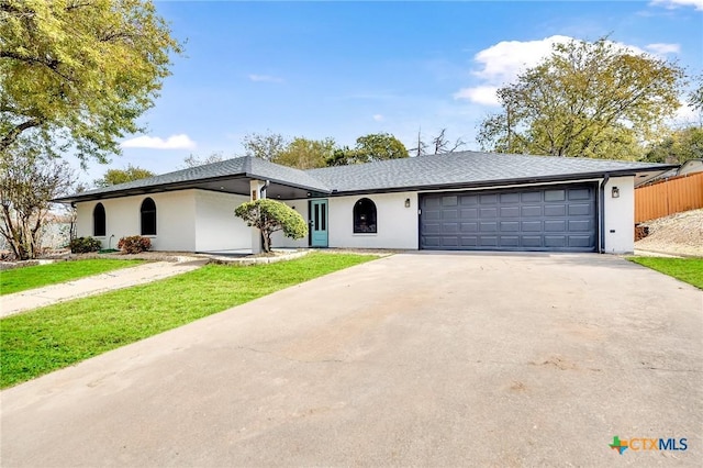 ranch-style home featuring a garage and a front yard