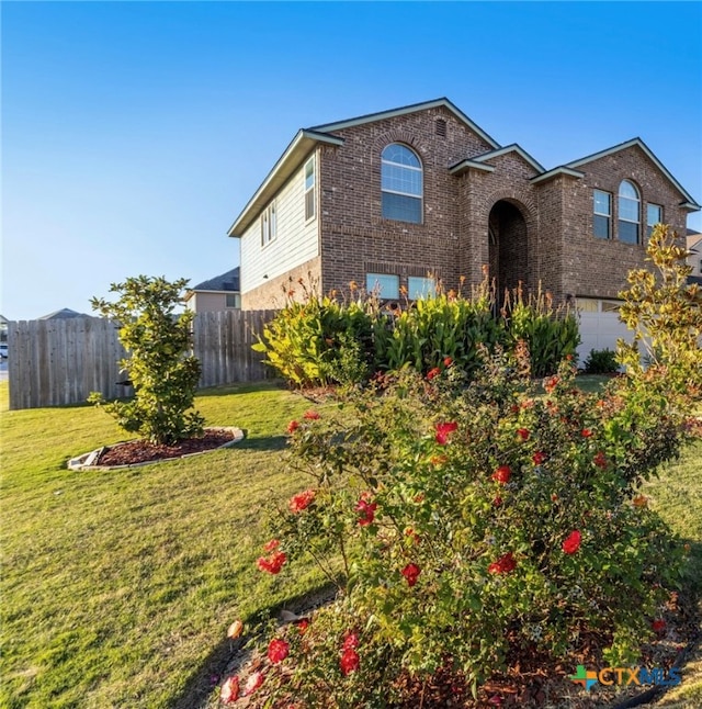 view of front facade featuring a front yard and a garage