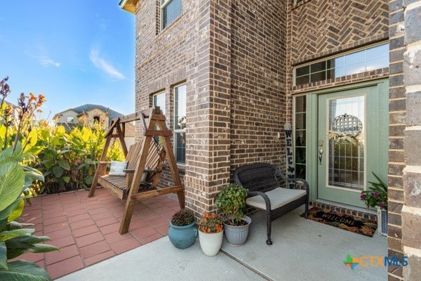 entrance to property with a patio area