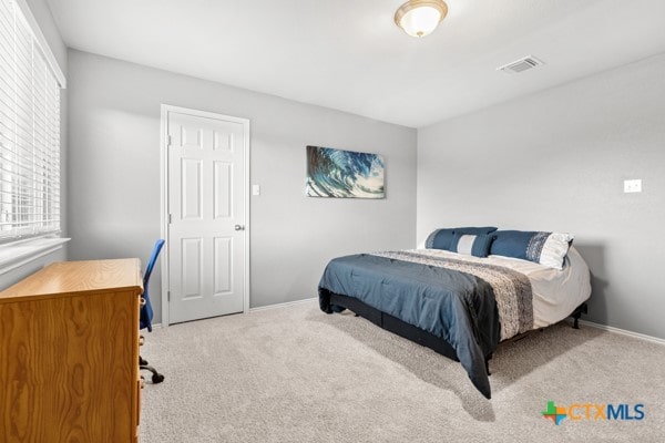 bedroom featuring light colored carpet