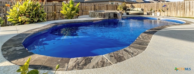 view of pool with pool water feature, an in ground hot tub, and a patio