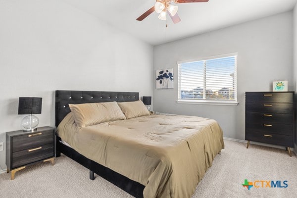 bedroom with light carpet and ceiling fan