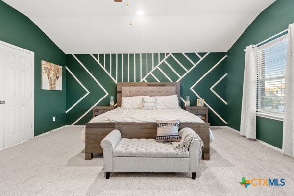 bedroom with vaulted ceiling and carpet flooring