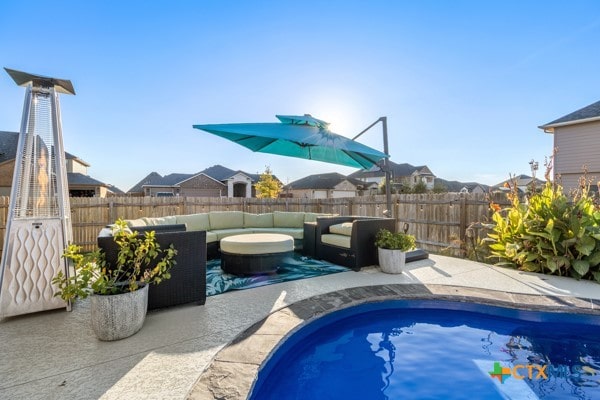 view of pool with an outdoor living space and a patio