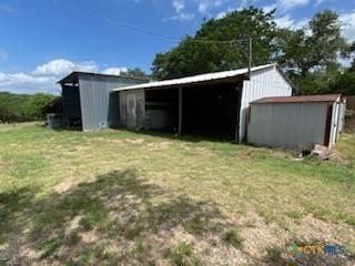 5342 Quail Hollow Dr, Temple, TX 76502 - view of green lawn with a storage unit, a pole building, and a carport