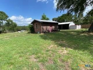 5342 Quail Hollow Dr, Temple, TX 76502 - view of grassy yard with a carport and a storage unit