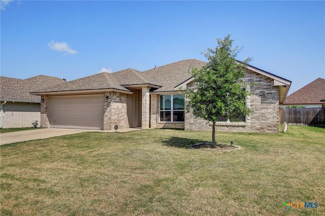 single story home with fence, concrete driveway, a front yard, and a garage