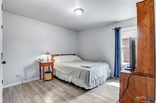 bedroom featuring baseboards and light wood-type flooring