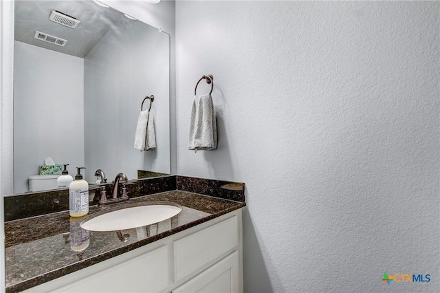 bathroom with visible vents and vanity