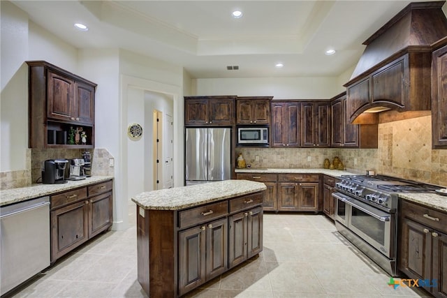 217 Foxwood, New Braunfels, TX 78132 - kitchen with appliances with stainless steel finishes, tasteful backsplash, recessed lighting, and a raised ceiling