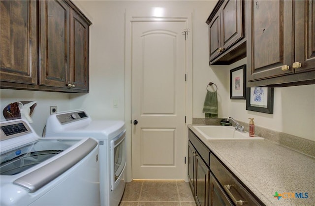 217 Foxwood, New Braunfels, TX 78132 - clothes washing area with a sink, cabinet space, light tile patterned flooring, and washing machine and clothes dryer