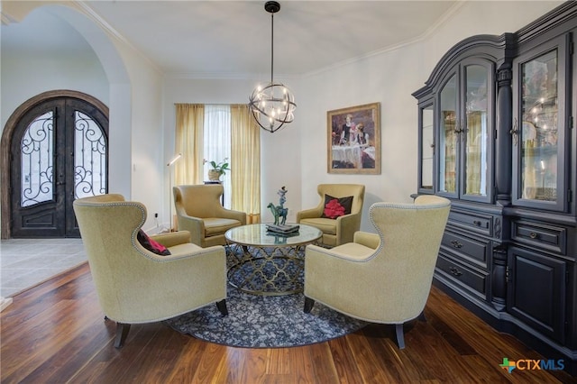 217 Foxwood, New Braunfels, TX 78132 - sitting room featuring ornamental molding, dark wood-type flooring, a chandelier, french doors, and arched walkways