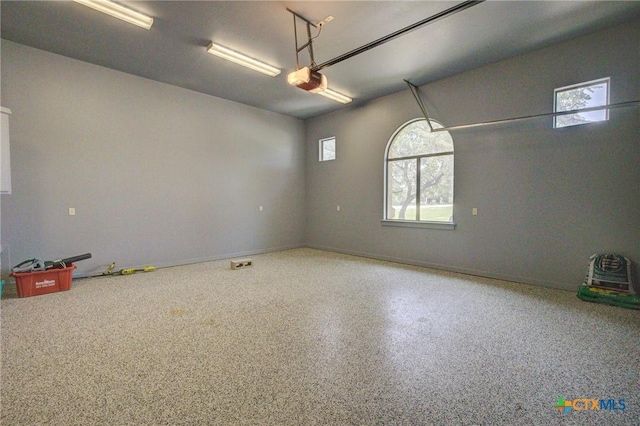 217 Foxwood, New Braunfels, TX 78132 - garage with baseboards and a garage door opener