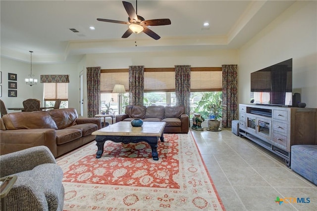 217 Foxwood, New Braunfels, TX 78132 - living area featuring ceiling fan with notable chandelier, light tile patterned floors, crown molding, and a tray ceiling