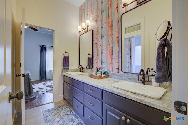 217 Foxwood, New Braunfels, TX 78132 - full bath featuring double vanity, a sink, a ceiling fan, and tile patterned floors