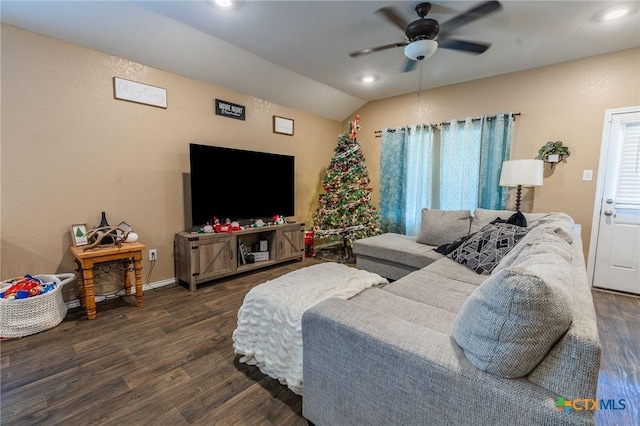 living room featuring ceiling fan, dark hardwood / wood-style flooring, and vaulted ceiling