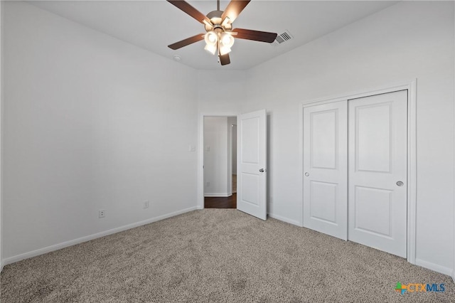 unfurnished bedroom with ceiling fan, a closet, and carpet