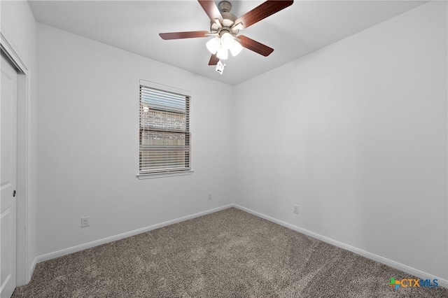 carpeted spare room with ceiling fan