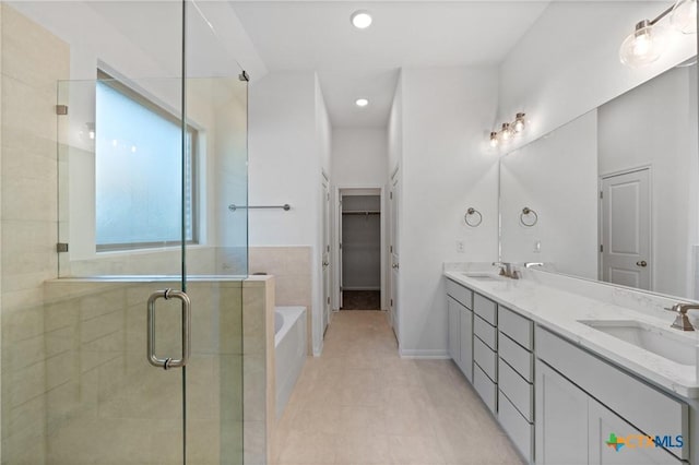 bathroom with shower with separate bathtub, vanity, and tile patterned floors