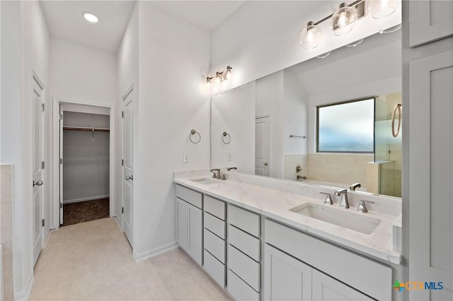 bathroom featuring vanity, tile patterned floors, and a bathing tub