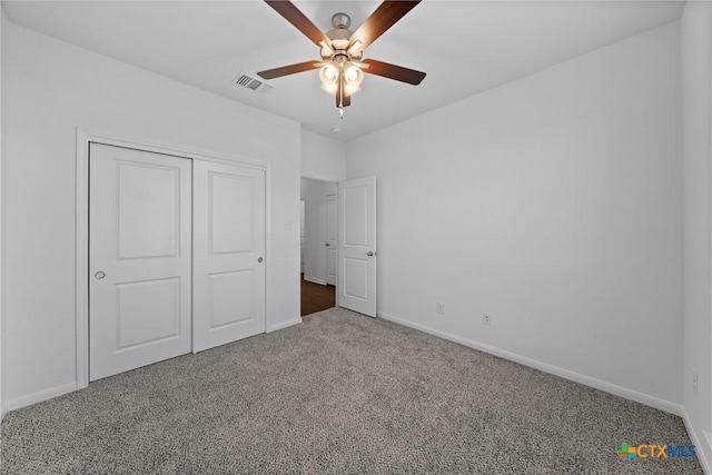 unfurnished bedroom featuring carpet floors, ceiling fan, and a closet