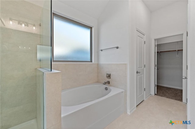 bathroom featuring shower with separate bathtub