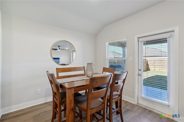 dining space with dark wood-type flooring, ceiling fan, and lofted ceiling