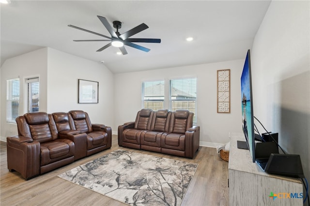 living room with plenty of natural light, ceiling fan, light wood-type flooring, and vaulted ceiling