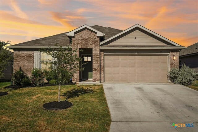 single story home with a garage and a front lawn