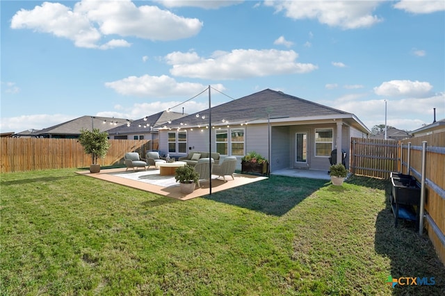 rear view of property with a yard, outdoor lounge area, and a patio