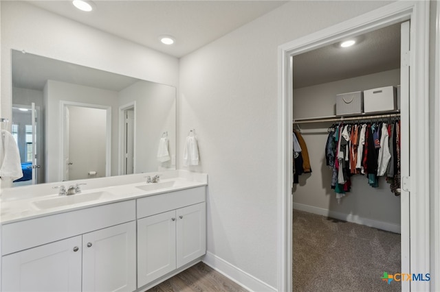 bathroom with hardwood / wood-style floors and vanity