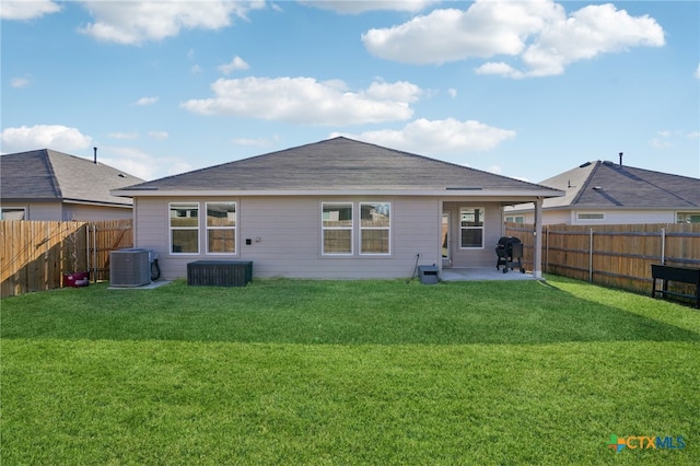 rear view of house featuring central AC, a patio area, and a yard