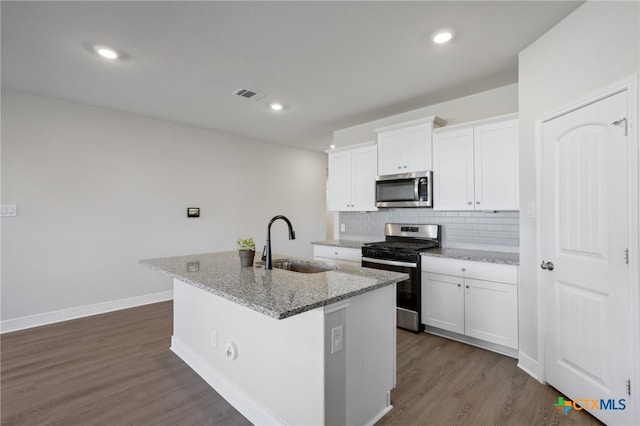 kitchen with a kitchen island with sink, white cabinetry, sink, and appliances with stainless steel finishes