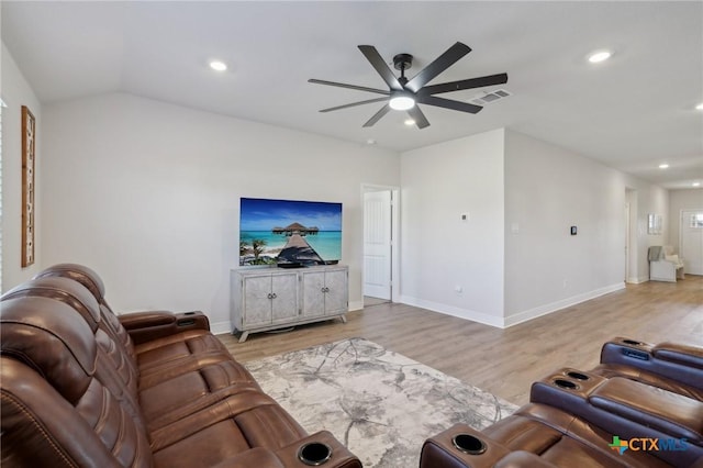 living room with light wood-type flooring, vaulted ceiling, and ceiling fan