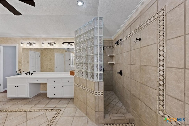 full bath featuring a walk in shower, a textured ceiling, vanity, tile patterned floors, and crown molding