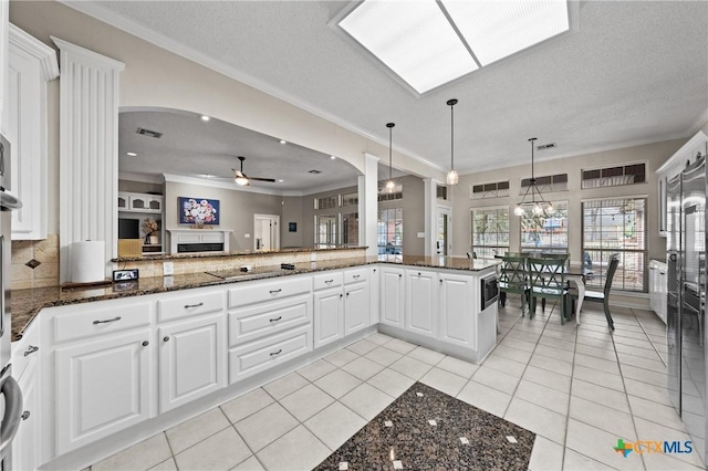 kitchen with ceiling fan, light tile patterned floors, black electric cooktop, and crown molding