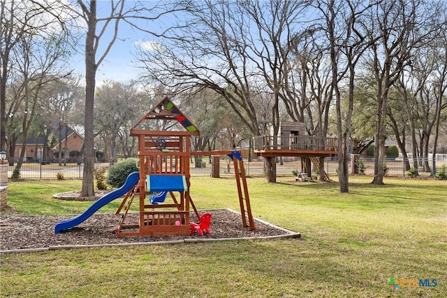 community jungle gym featuring a yard and fence