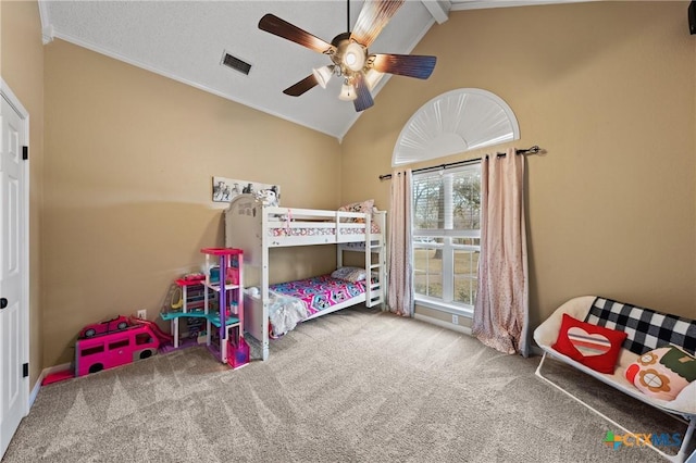 carpeted bedroom featuring lofted ceiling, ceiling fan, visible vents, and crown molding