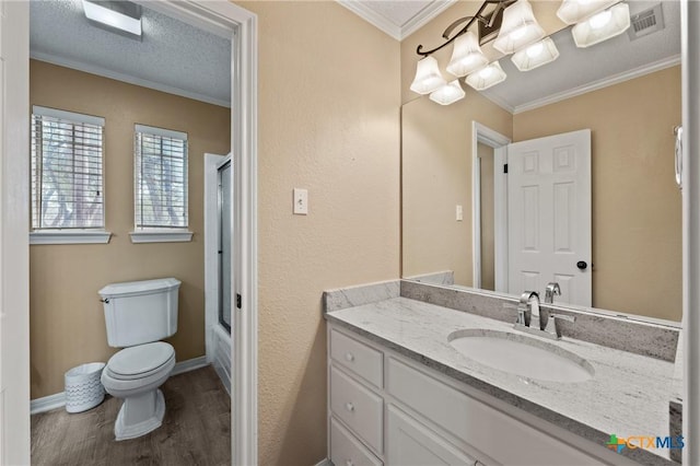 full bath with a textured ceiling, toilet, wood finished floors, vanity, and ornamental molding