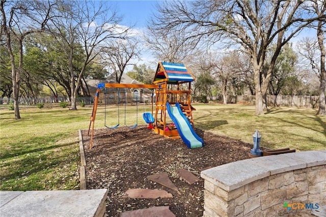 view of jungle gym with a yard and fence