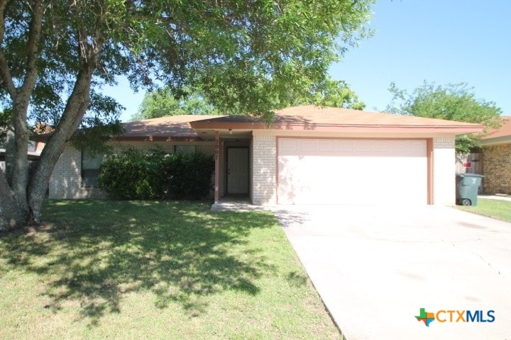 ranch-style home with a front yard and a garage